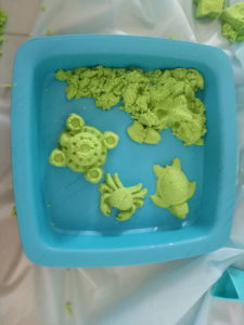sensory kinetic sand playing with molds