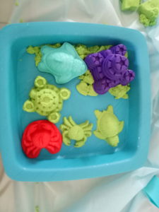 sensory kinetic sand playing with molds